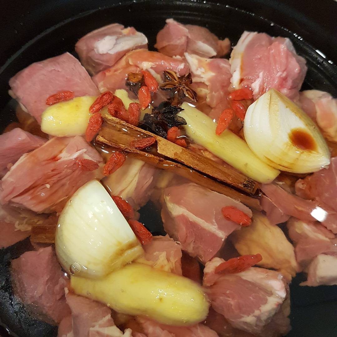 Picture of meat and vegetagbles in a broth and pot uncooked